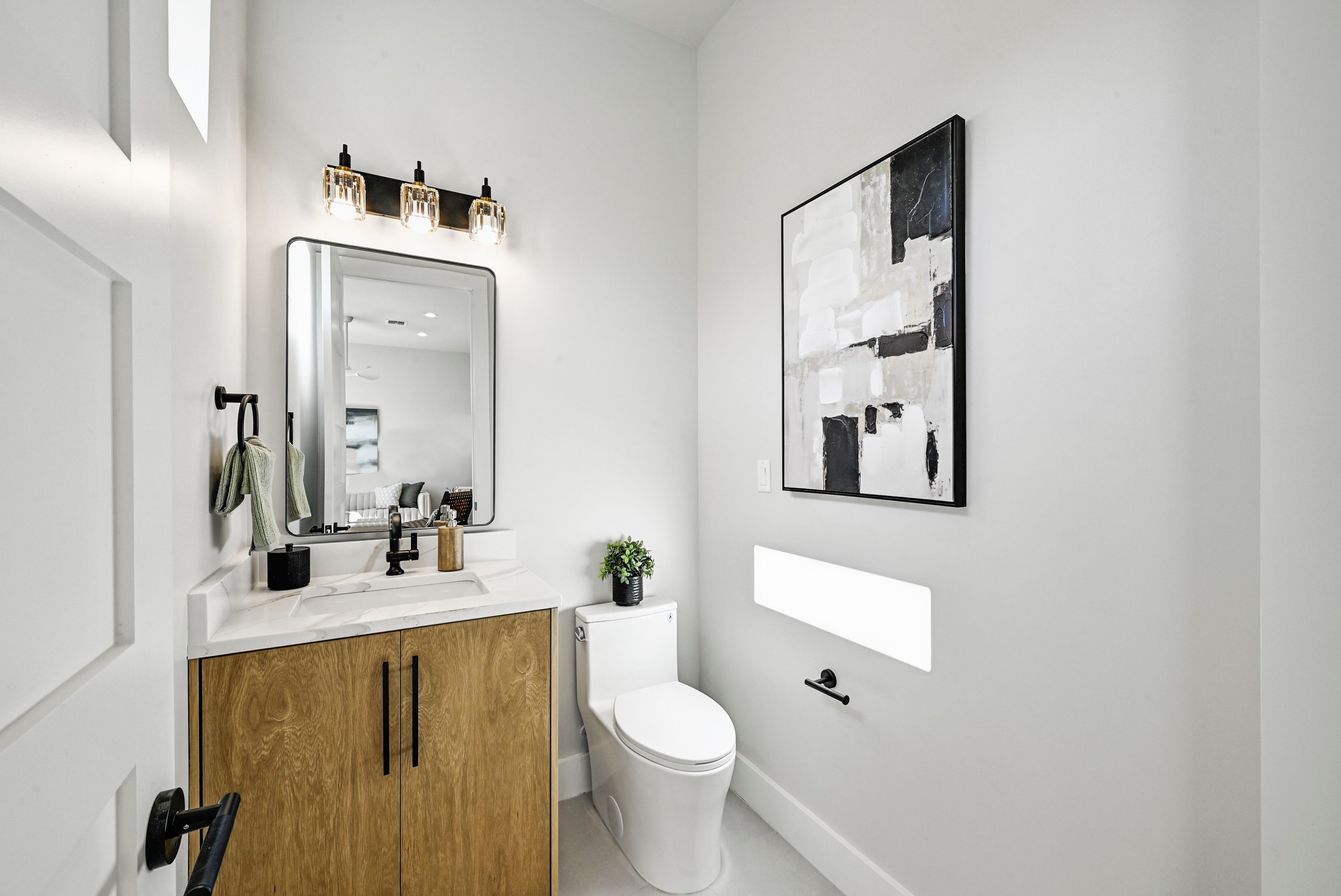 100 West Odell Street, Unit 3 Austin, TX 78752 - Photo 23 of 37 a bathroom with a toilet sink and mirror