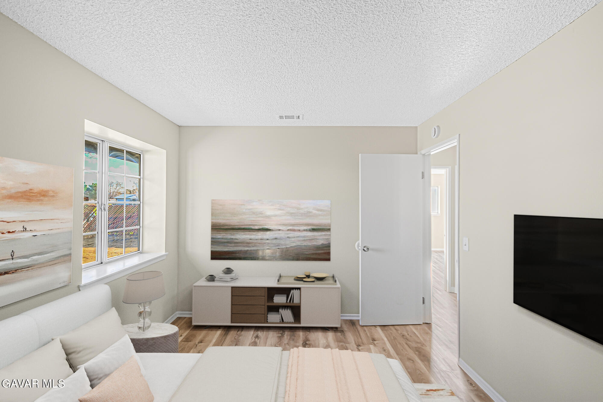 40523 172nd Street East Lancaster, CA 93535 - Photo 12 of 20 a living room with furniture a flat screen tv and kitchen view