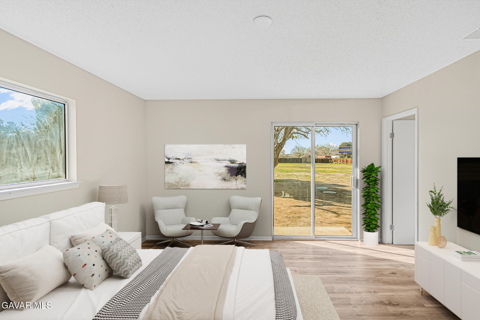 40523 172nd Street East Lancaster, CA 93535 - Photo 7 of 20 a bedroom with a large bed and a flat tv screen