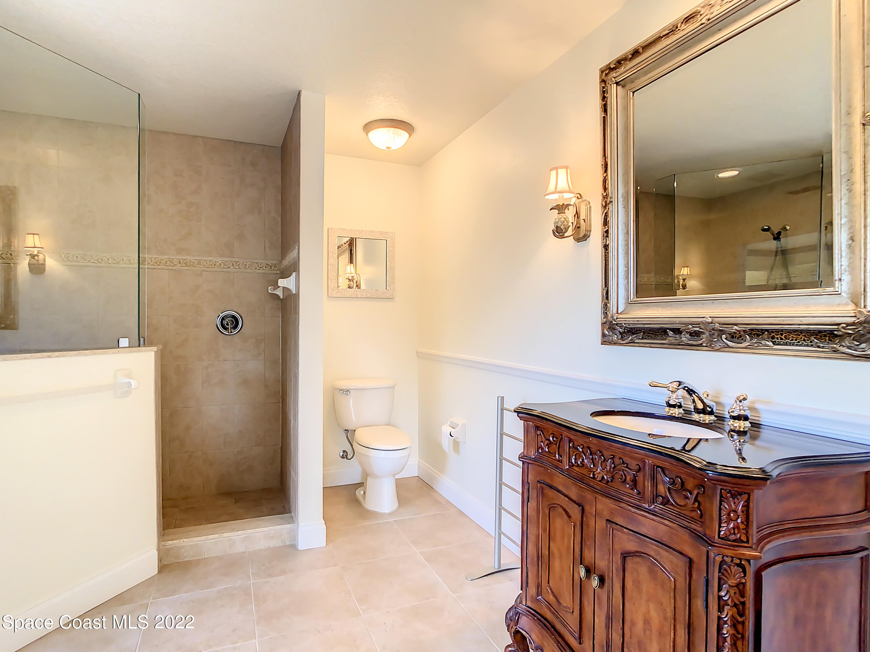 1845 Rustic Lane Melbourne, FL 32934 - Photo 30 of 35 a bathroom with a sink a toilet and shower