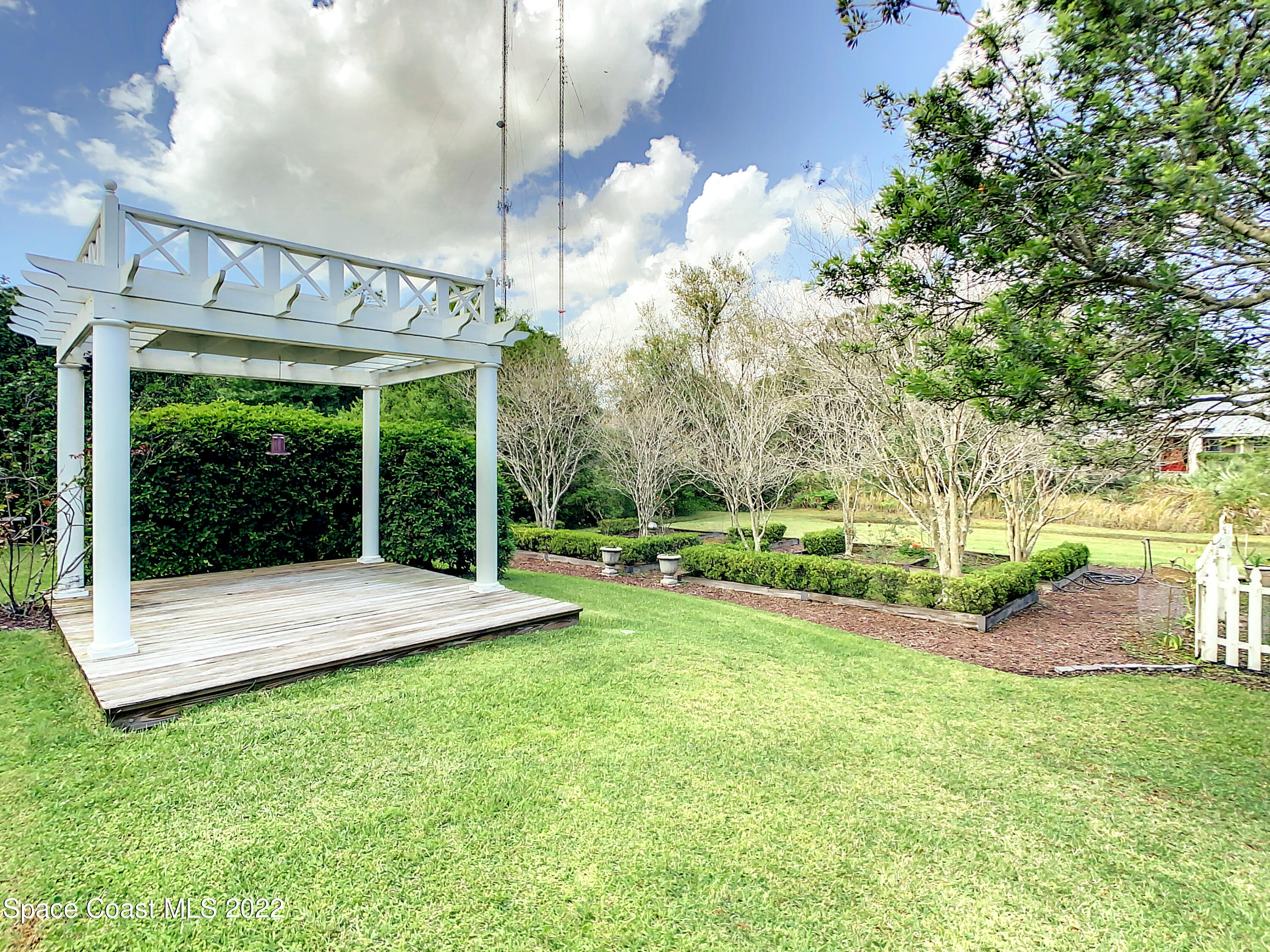 1845 Rustic Lane Melbourne, FL 32934 - Photo 5 of 35 a view of a backyard with table and chairs and potted plants