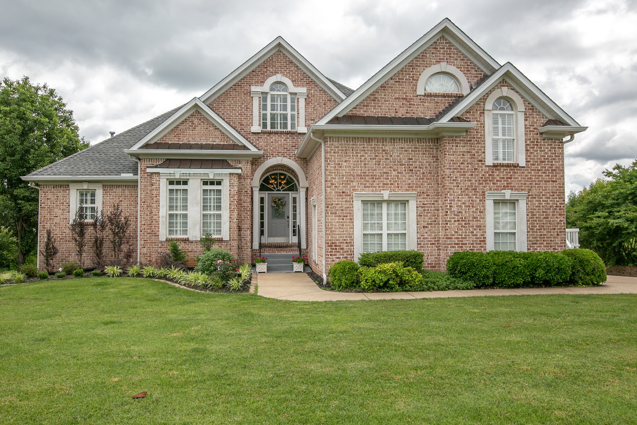a front view of a house with a yard
