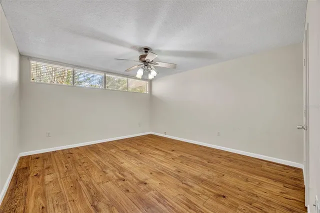 a view of an empty room and wooden floor