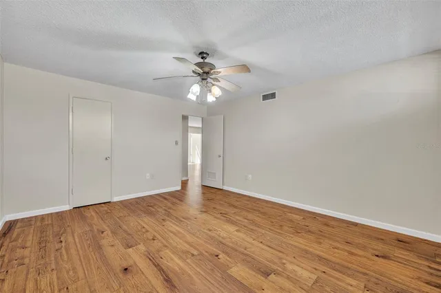 a bathroom with a granite countertop sink toilet a mirror and shower