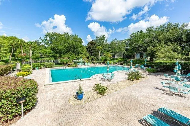 a view of a patio with a table chairs and a fire pit