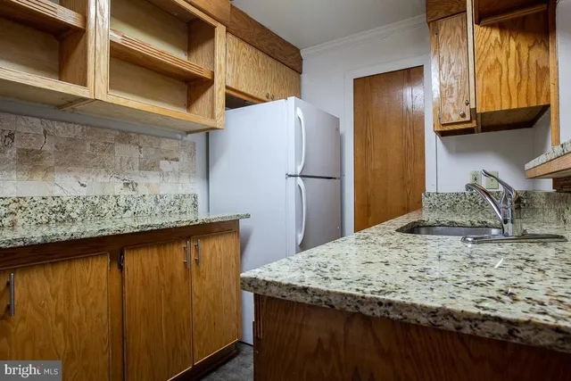 a view of a kitchen counter space and a refrigerator