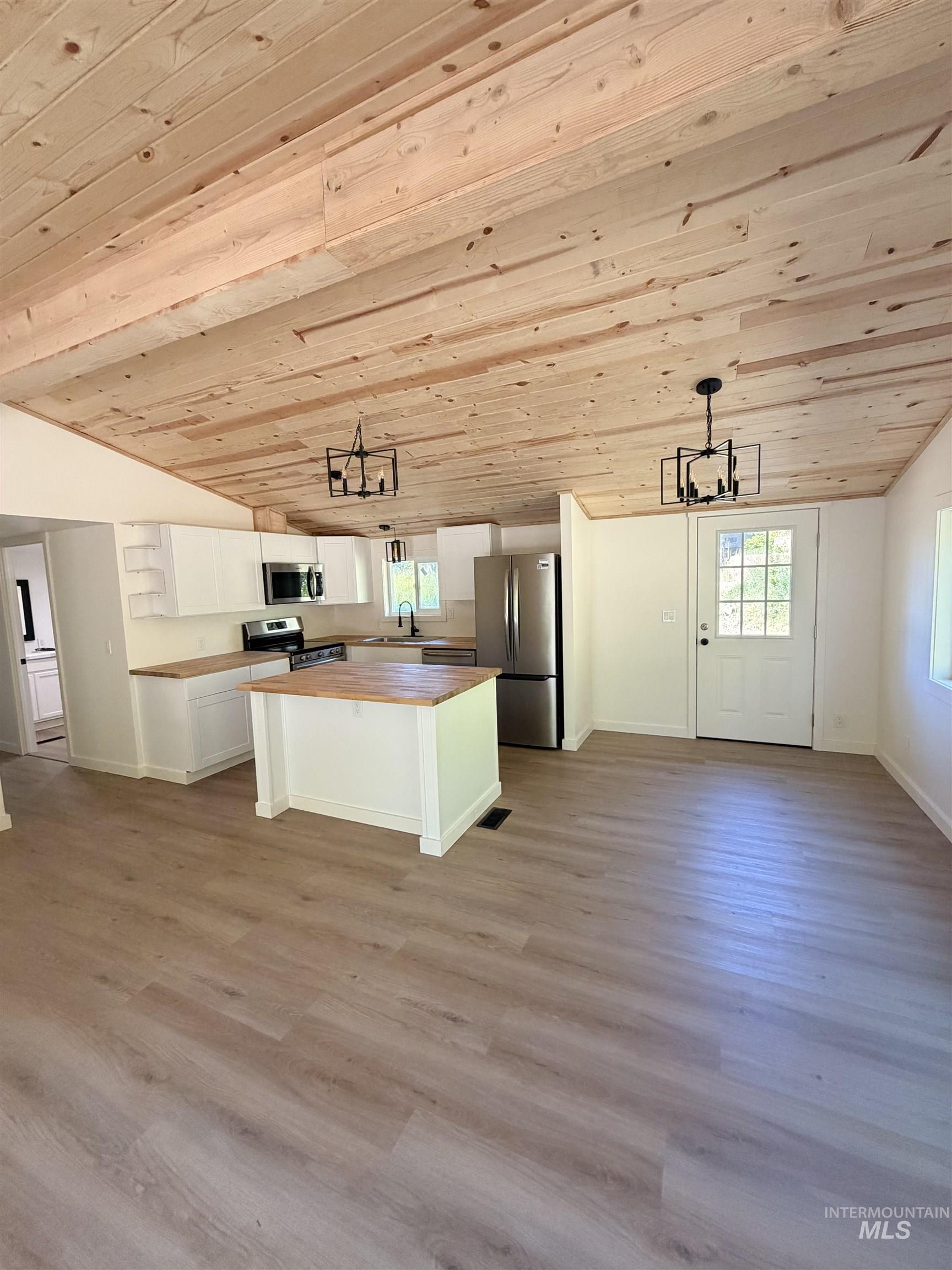 151 View Road Kamiah, ID 83536 - Photo 3 of 49 Open concept living area featuring a wood-finish vaulted ceiling with two contemporary light fixtures