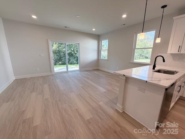 211 Queens Court Gastonia, NC 28052 - Photo 13 of 48 a kitchen with kitchen island a sink wooden floor and a large window