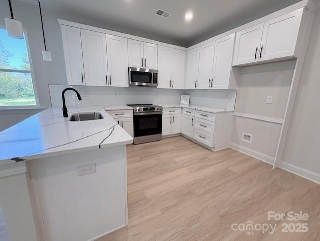 211 Queens Court Gastonia, NC 28052 - Photo 6 of 48 a kitchen with white cabinets and appliances