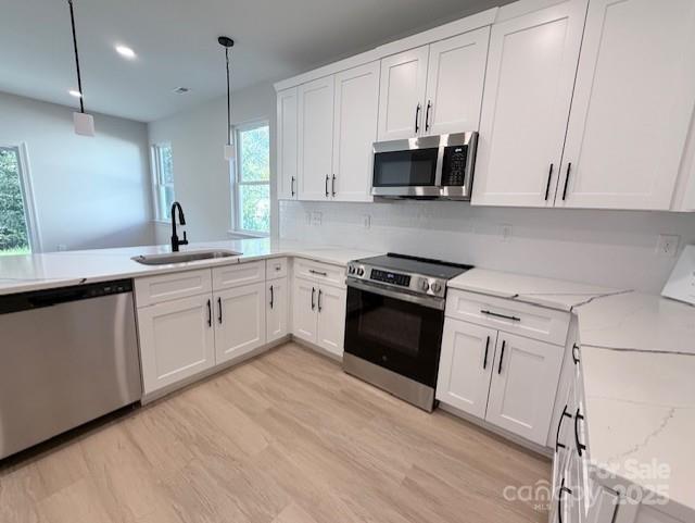 211 Queens Court Gastonia, NC 28052 - Photo 9 of 48 a kitchen with stainless steel appliances granite countertop a stove a sink and white cabinets