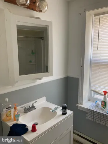 a bathroom with a sink and a window