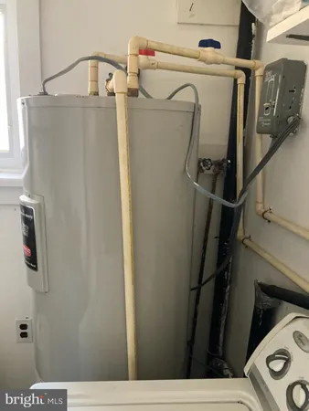 a view of storage and utility room with refrigerator