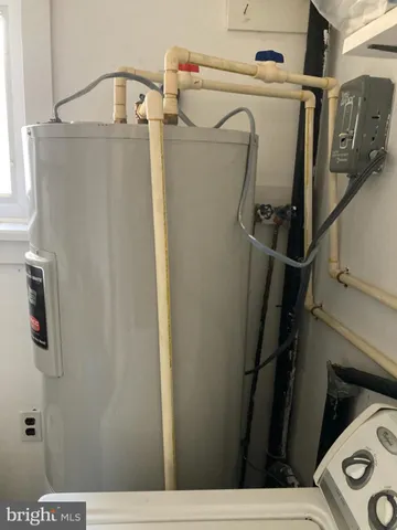 a view of storage and utility room with refrigerator