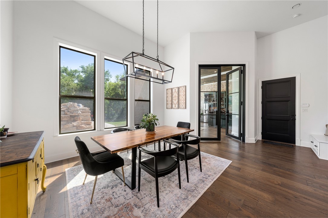 1351 River Road Waco, TX 76705 - Photo 21 of 96 a dining room with furniture a chandelier and wooden floor