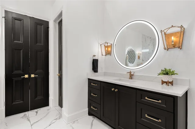 a kitchen with stainless steel appliances granite countertop a sink and a refrigerator