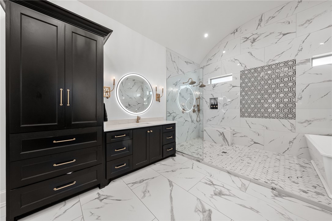 1351 River Road Waco, TX 76705 - Photo 27 of 96 a bedroom with a bed a mirror on dresser and a chandelier