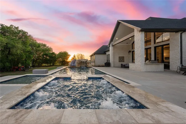 a kitchen with stainless steel appliances kitchen island granite countertop a wooden floor and white cabinets