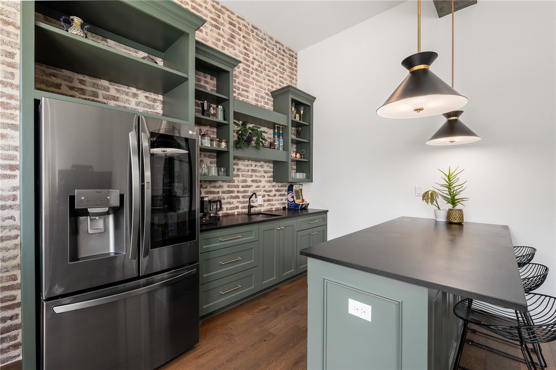1351 River Road Waco, TX 76705 - Photo 43 of 96 a kitchen with stainless steel appliances granite countertop a sink and a refrigerator