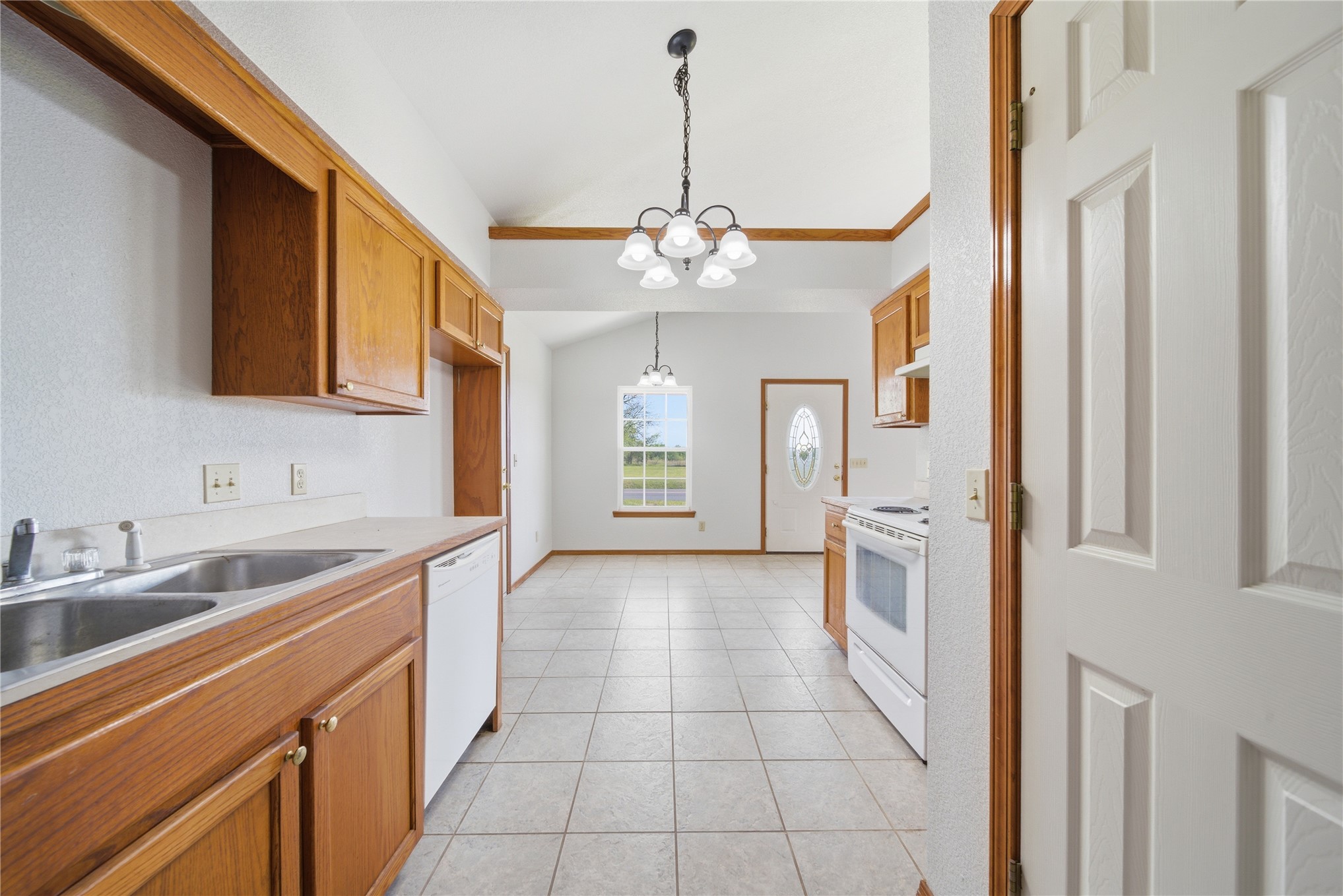 511 Cemetery Road Oktaha, OK 74450 - Photo 14 of 28 Kitchen featuring wood cabinetry, a dual basin sink, white appliances, and tiled flooring
