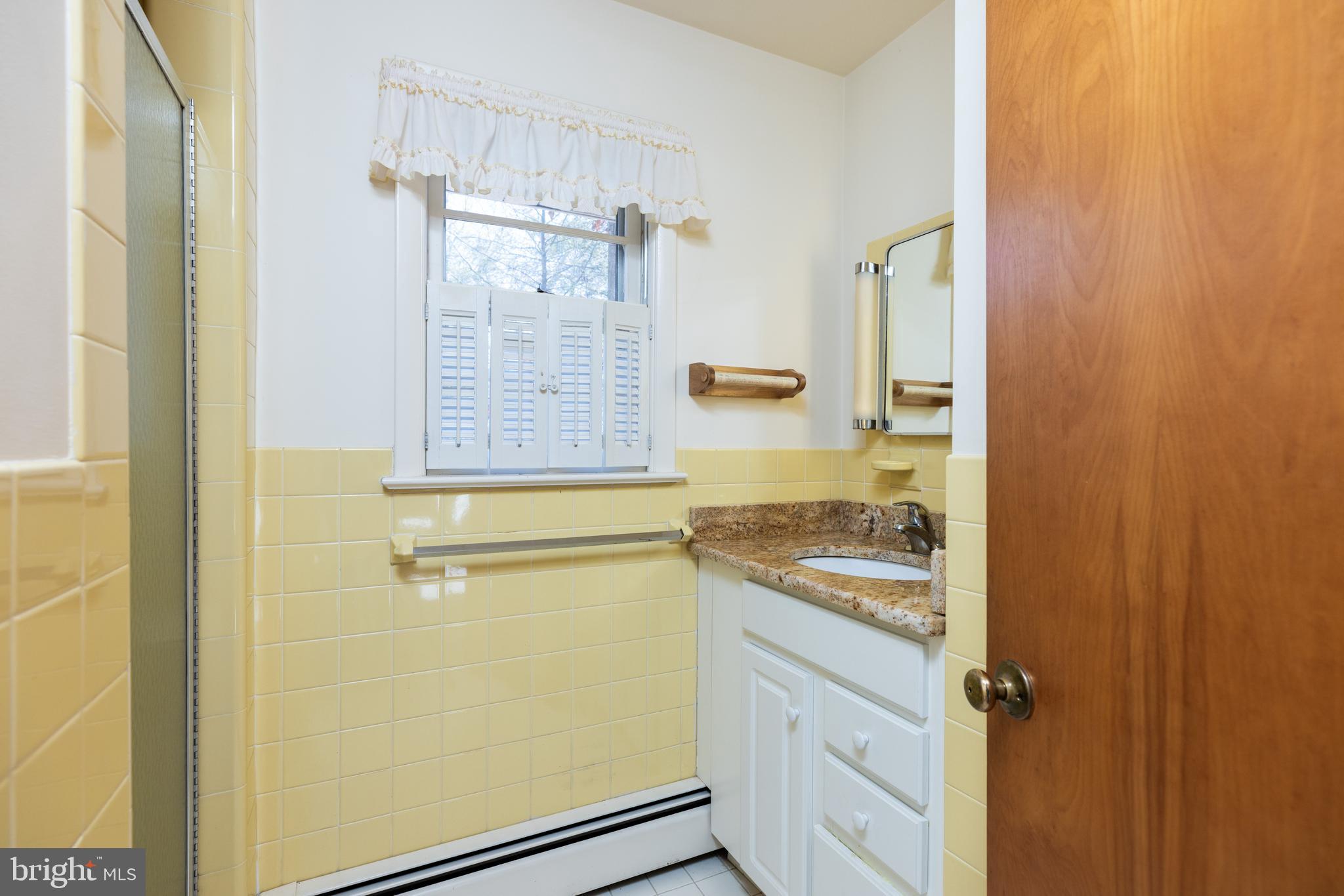 31360 Point Circle Lewes, DE 19958 - Photo 24 of 42 a bathroom with a granite countertop sink a mirror and shower