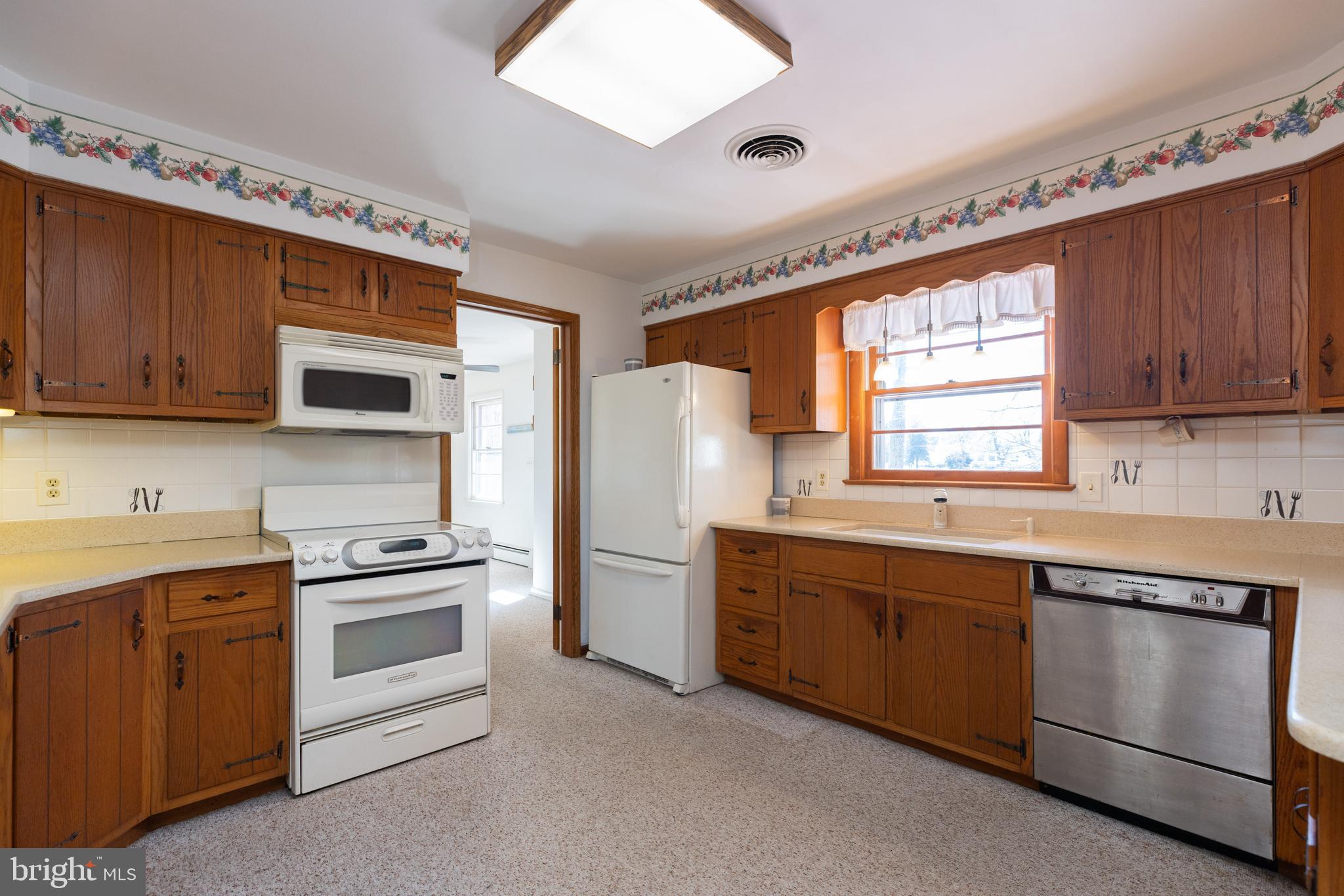 31360 Point Circle Lewes, DE 19958 - Photo 5 of 42 a kitchen with stainless steel appliances granite countertop a sink stove and refrigerator