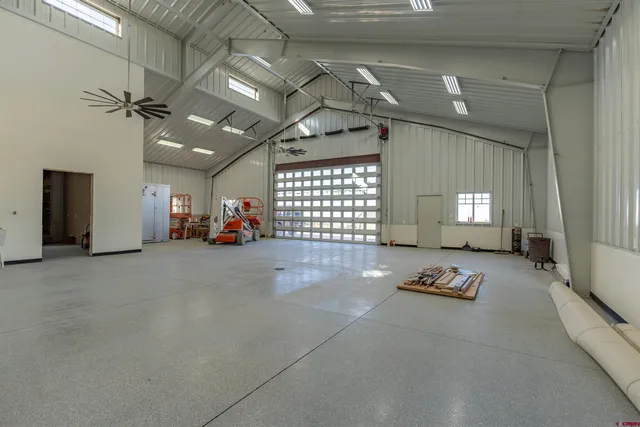 a living room with furniture gym equipment and a window