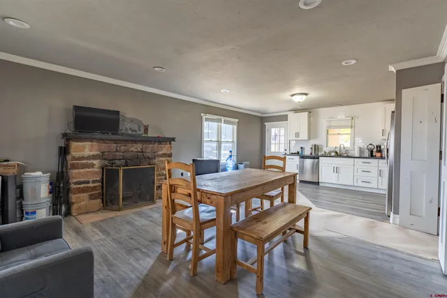 a dining room with furniture and wooden floor