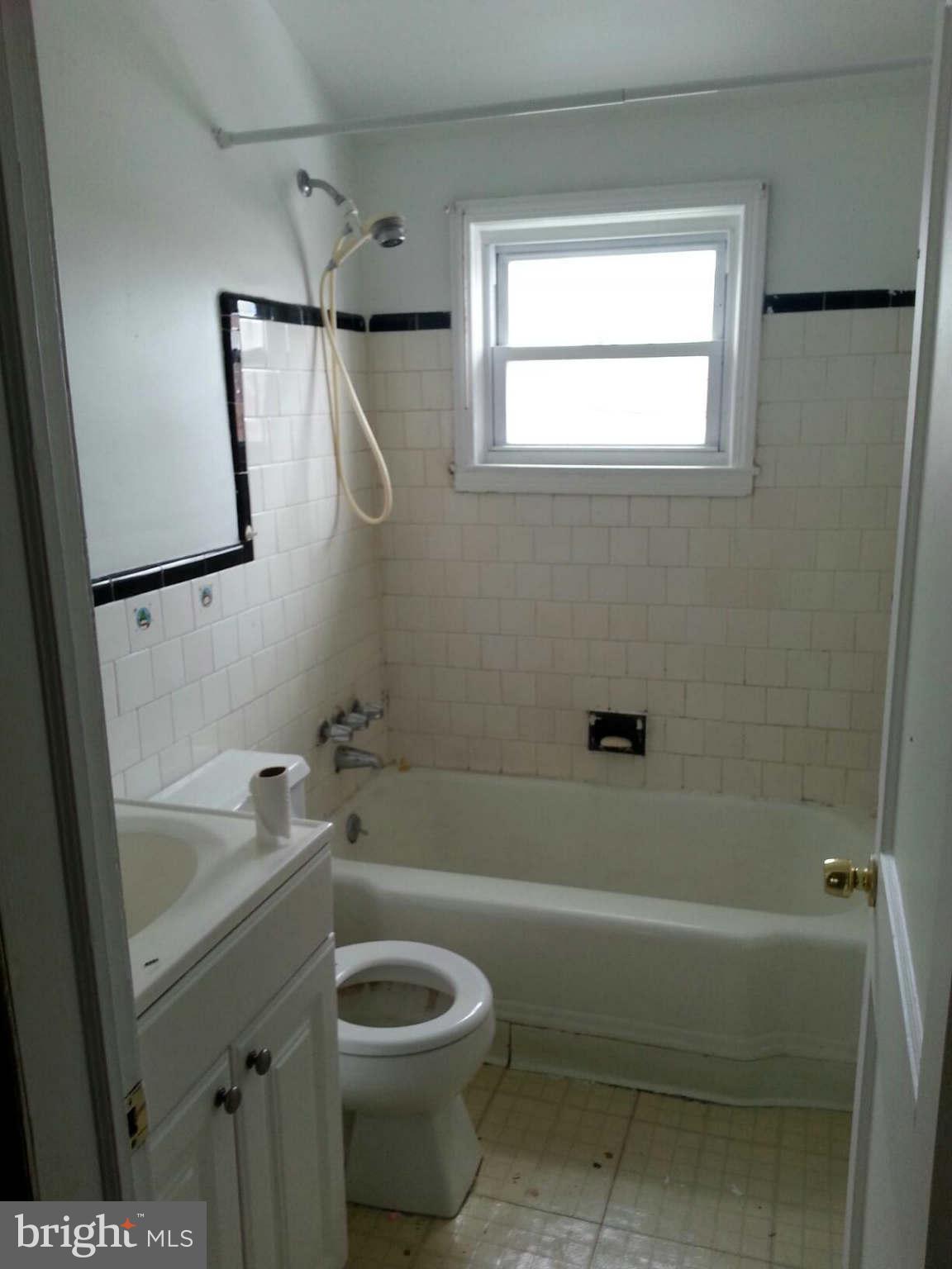 934 Arncliffe Road Baltimore, MD 21221 - Photo 5 of 5 a bathroom with a sink a toilet and shower