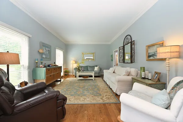 a living room with furniture a fireplace and a chandelier