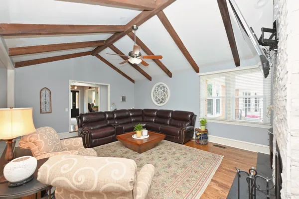 a living room with furniture and a chandelier