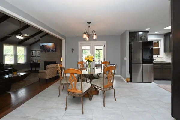 a kitchen with stainless steel appliances granite countertop a refrigerator a sink a stove and oven