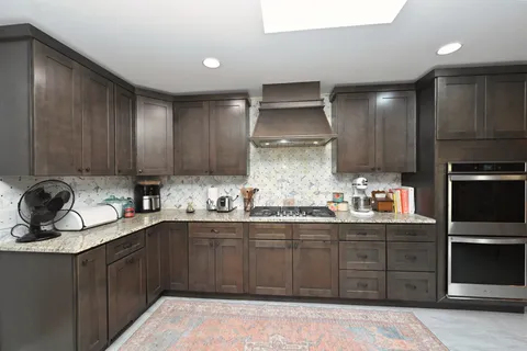 a kitchen with a sink stainless steel appliances and cabinets