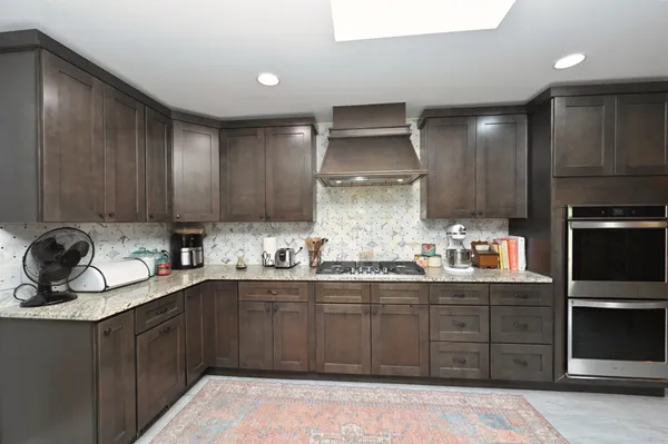 a kitchen with a sink stainless steel appliances and cabinets
