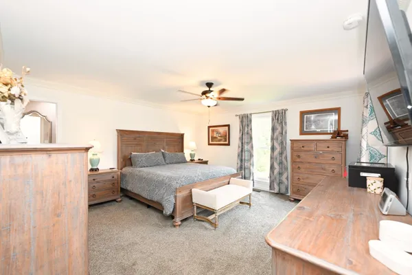 a bedroom with a bed and a chandelier