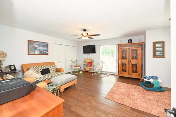 a living room with furniture and wooden floor