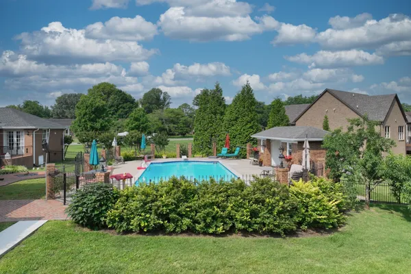 a view of a house with a big yard and potted plants