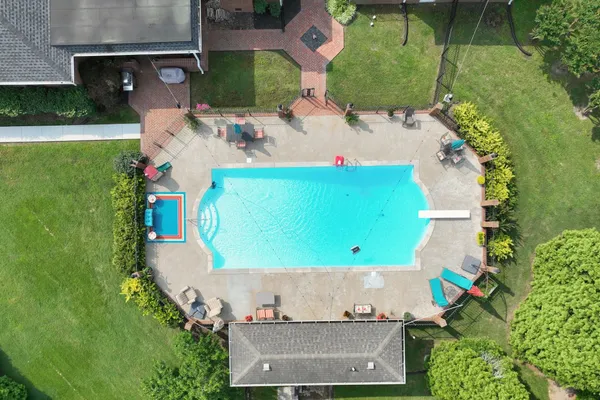 an aerial view of a house with a yard