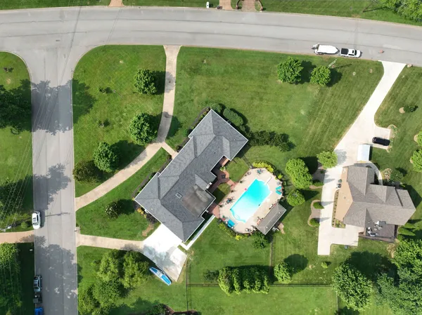 an aerial view of a house with a yard
