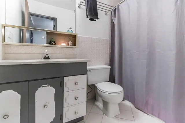 a bathroom with a sink toilet and mirror