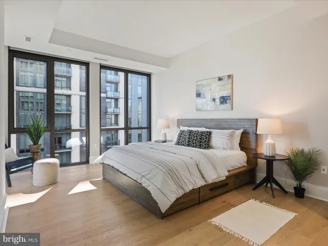 a spacious bedroom with a bed and a large window