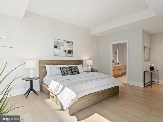 a spacious bedroom with a bed and a table in it