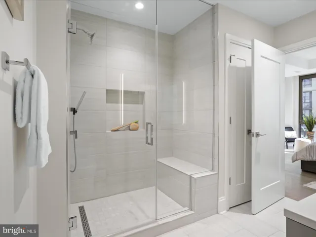 a bathroom with a shower and a sink