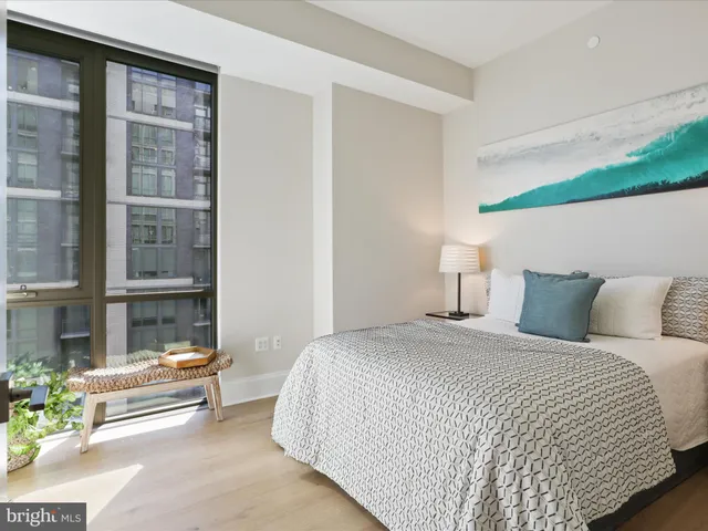 a bedroom with a bed and a window