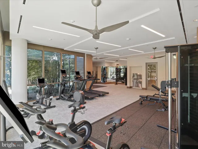 a room with gym equipment and large window