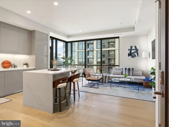 a living room with kitchen island furniture and a large window
