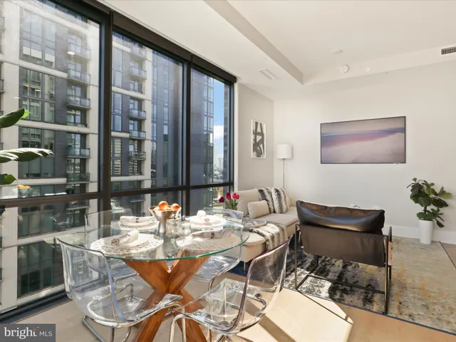 a dining room with furniture a rug and a painting