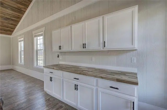 a large kitchen with stainless steel appliances granite countertop a sink refrigerator and stove