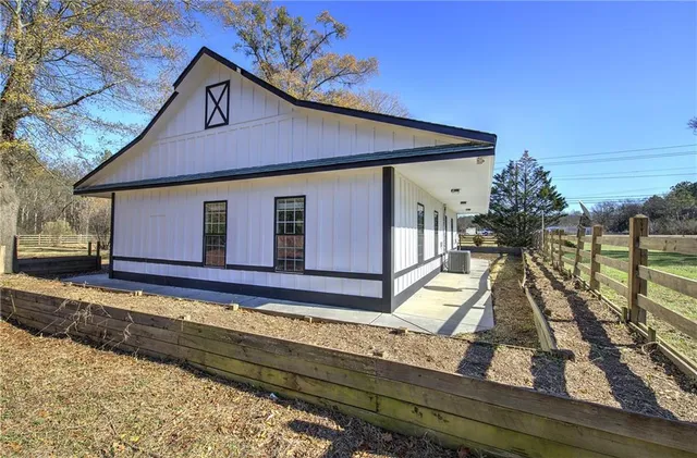 a view of a house with wooden floor next to a yard