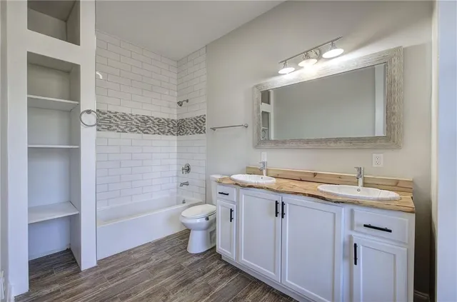 a bathroom with a granite countertop sink a mirror and a window
