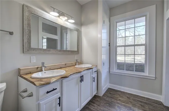 a view of hallway with stairs and wooden floor